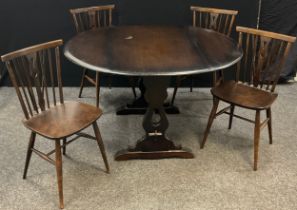 An Ercol style drop-leaf dining table, and set of four 1970’s design chairs, (5).