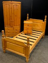 A pine bedroom suite, comprising, single bed, single wardrobe, and bedside chest of drawers. The bed