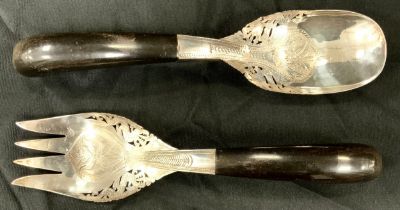 A pair of Middle eastern silver serving spoons, horn handles, ornate tines and bowl, stamped