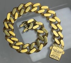 A yellow metal curb link bracelet, enamelled ZZ clasp, stamped 750, 19cm long, 1.1cm wide, 17.7g