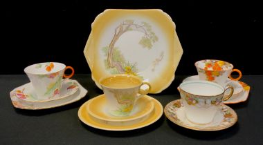 A group of art deco Shelley tea ware comprised of; ‘Enamelled flowers Acacia’ tea cup trio,