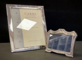 A contemporary silver rectangular photograph frame, Carrs Sheffield 2007, 30cm x 24.5cm; another