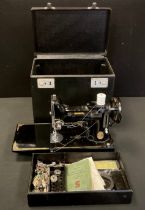 A Singer Featherweight portable electric sewing machine, No. 221K, serial No EG352451, in black with