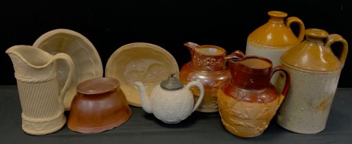 Brampton salt glaze moulded jug,18cm high, another, stoneware flagons, a set of three blancmange