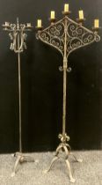 A wrought iron floor standing candelabra / electrolier, 158cm high x 60cm wide; another smaller