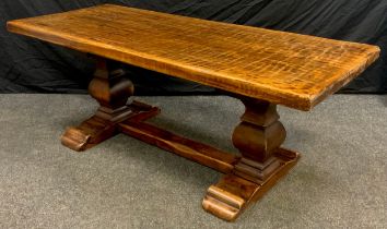 A solid oak and stained beech coffee table, adzed top, square baluster-form supports, 53cm high x