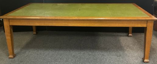 An Arts and Crafts style oak boardroom table, tooled green leather inset top, tapered square legs,