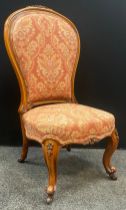 A Victorian carved walnut nursing chair, 104cm high x 52cm wide, c.1860.