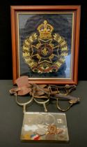 A pair of World War one Cavalry spurs, others Royal Army Service Corp cap badges, hand embroidered