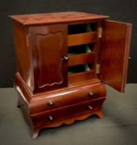 Miniature Furniture - a mahogany bombe shaped linen press