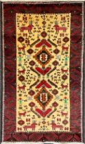 A North-east Persian Meshed Belouch rug, hand-knotted with double diamond-form medallions within a