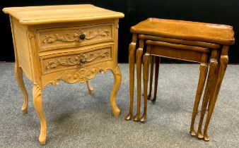 A Louis XV style oak bedside cabinet / chest of drawers, serpentine shaped top, two short drawers,
