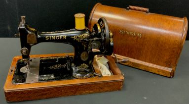 A singer sewing machine, manufactured in Clydebank Scotland, 1910, arch-top oak case, serial