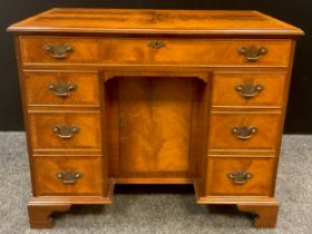 A George II style walnut knee-hole desk, 76cm high x 92.5cm wide x 49.5cm deep, 20th century.