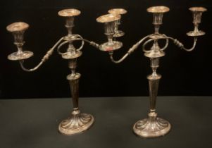 A pair of 19th century silver plated three branch candelabrums, oval bases, 47cm high