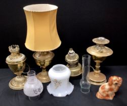 A group of four brass oil lamps (converted into electric), 26cm - 35cm; etc (4)