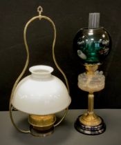 A Victorian oil lamp, clear moulded glass reservoir, brass reeded column, ring stepped foot, black