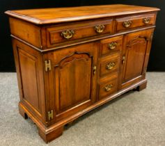 A walnut sideboard by Simon Simpson, of Norwich, yew-wood cross-banded top, two long drawers to