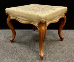 An early Victorian walnut stool, needlework upholstered seat, serpentine shaped sides, serpentine