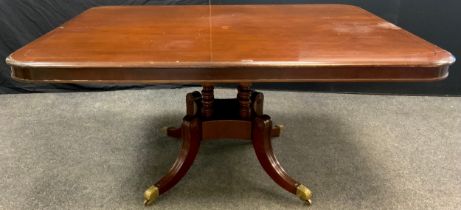 A William IV style mahogany pedestal dining table, rounded rectangular tilting top, turned supports,