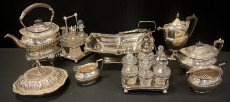 A Victorian four piece silver plate tea set, Christopher Dresser style cruet set, another cruet set,