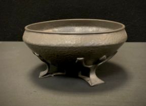 A early 20th century Liberty and Co pewter bowl, hammered vessel supported by three open work