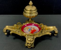 A Louis XVI style porcelain and brass desk stand inkwell, covered inkwell above pieced scrolling