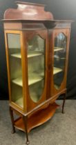 An Edwardian mahogany Vitrine or china display cabinet, shaped quarter-galleried back, break-