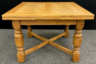 A solid oak draw-leaf dining table, thick turned baluster-form supports, x-frame stretcher, 75cm