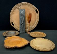 A carved circular fruitwood tray, with leafy bands and floral rosettes, loop handles, 47.5cm