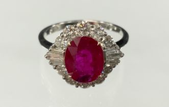 A certified ruby and diamond ring, central oval mixed cut ruby, 2.05ct, surrounded by sixteen