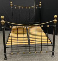 A Victorian style metal double bed frame, 149cm high at headboard x 202cm long x 137cm wide (