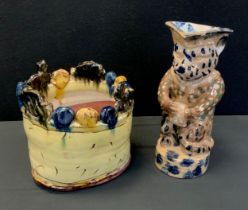 A early 18th century Staffordshire jug, 28cm high, an unusual planter in tones of yellows, blues and