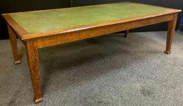 An Arts and Crafts style oak boardroom table, tooled green leather inset top, tapered square legs,