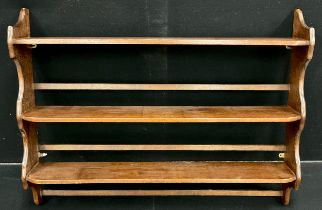 A walnut stained hardwood three tier plate rack, wall mounted, 82.5cm high x 107cm wide x 16cm deep.