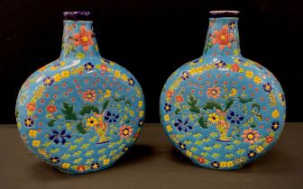 A pair of powder blue moon flasks, decorated with multi coloured flowers, 28cm high (2)