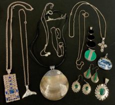 Jewellery - a malachite silver mounted two panel pendant, another sunburst pendant and pair of