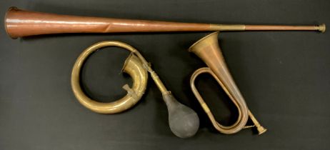A copper and brass coaching horn, bearing label was used on the Dartmouth Stagecoach, 91cm long, 9.
