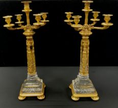 A pair of Egyptian revival Renaissance style gilt metal and glass candelabra, each with four branch