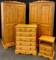 A Pine bedroom suite - pair of wardrobes, 192cm high x 101.5cm wide x 52cm; chest two short over