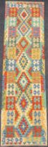 A Turkish Anatolian Kilim rug, knotted with traditional geometric design in tones of blue, green