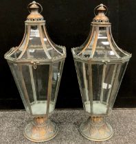 A pair of copper coloured metal lanterns, tapering octagonal shape, with decoration in relief,