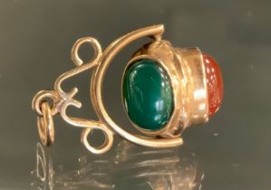 A 9ct gold revolving three cabochon pendant, with carnelian, garnet and green cabochon panels,