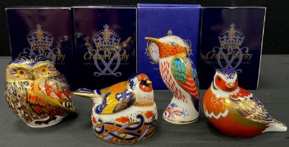 A group of four Royal Crown Derby paperweights including; Nesting Goldfinch, Humming Bird,