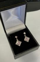 A pair of pink sapphire and diamond square cluster drop earrings, each with two pink sapphires and