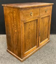 An early to mid 20th century oak side cupboard, over-sailing rectangular top, pair of drawers to