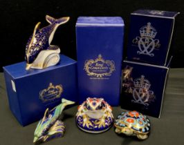 A group of four Royal Crown Derby paperweights including; a Dolphin, gold stopper, Baby Bottlenose