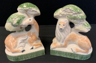 A pair of Rye Pottery bookends, moulded with Lion and Unicorn beneath Trees, 20cm high (2)