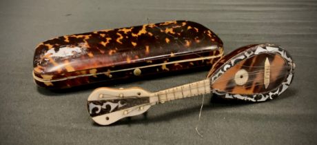 A 19th century tortoiseshell rounded rectangular cigar case, 15cm wide, c.1860; a miniature