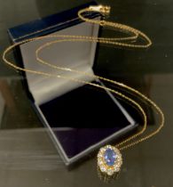 A sapphire and diamond pendant necklace, oval light blue sapphire approx 0.55ct surrounded by ten